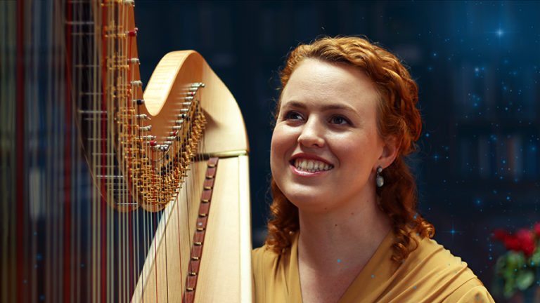 Christy-Lyn in a yellow dress with a pedal harp