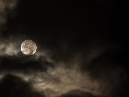 Dark, cloudy night sky with full moon